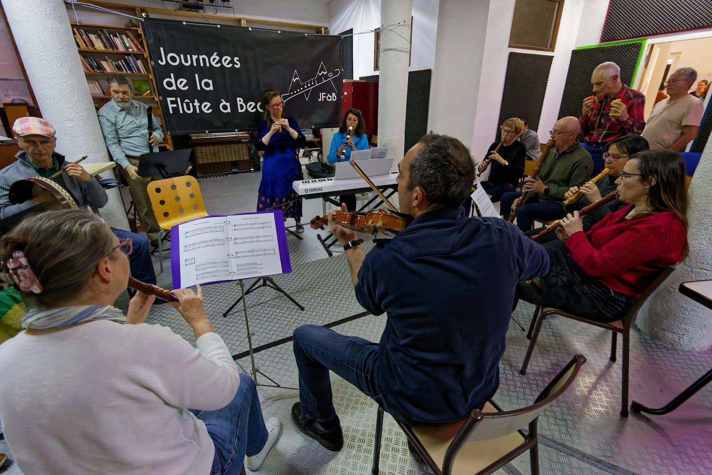A group of musicians playing instruments during a music workshop.