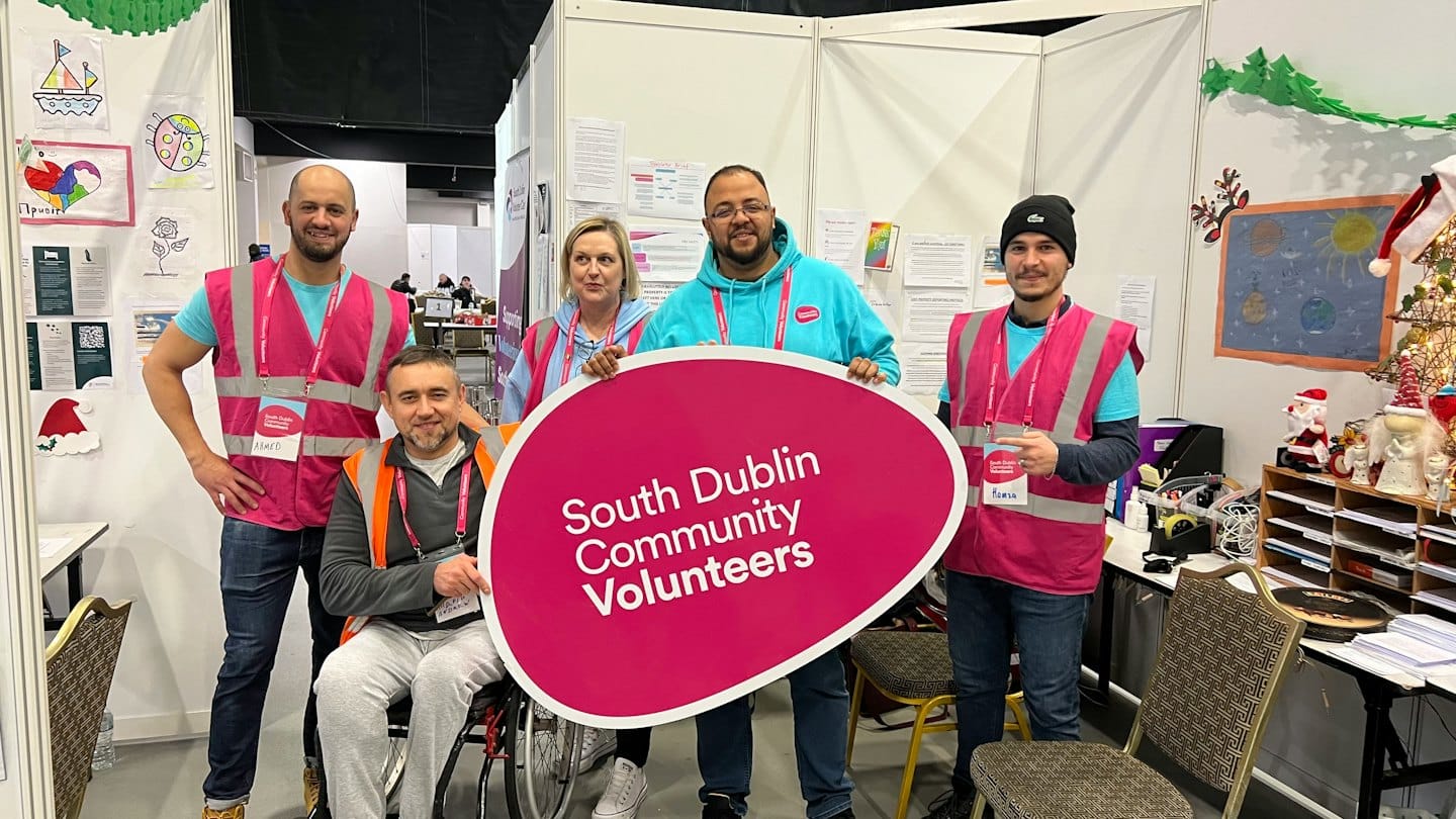 Five volunteers hold a South Dublin Community Volunteers sign.